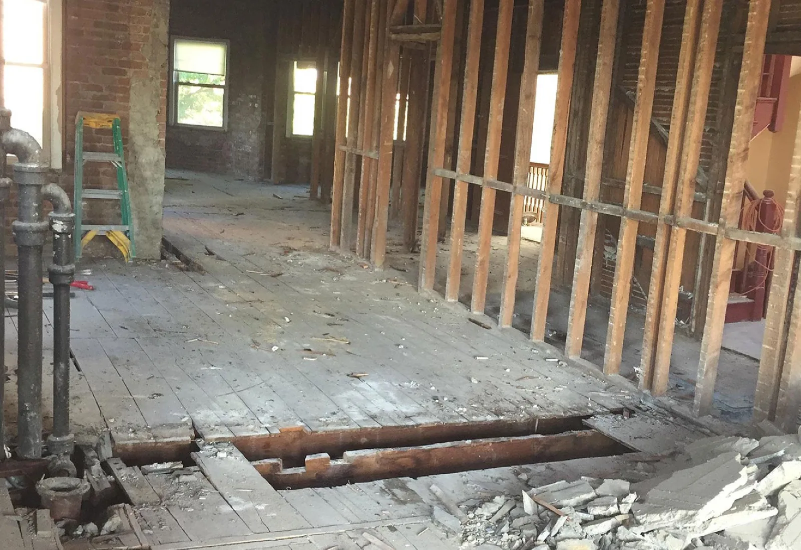 Interior stripped back to studs and brick with the floor cleared